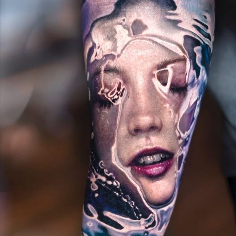 Artista Del Tatuaje Aplica Tatuaje Al Brazo. Ella Está Llenando De